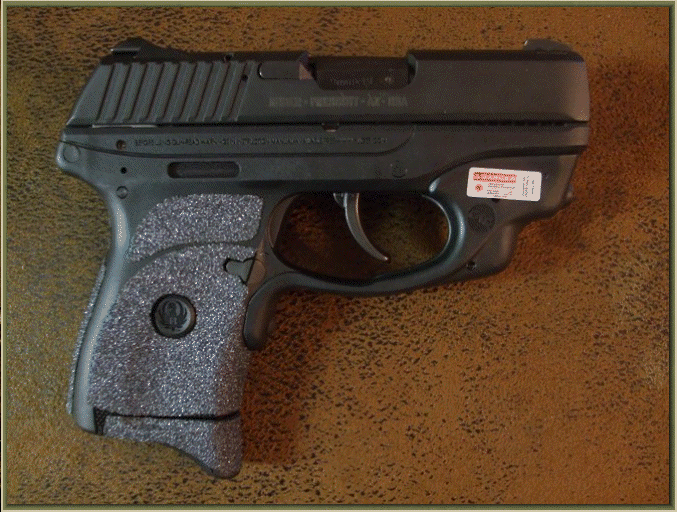Image of Ruger LC9 With Crimson Trace Grip Activated Laser with grip enhancements.
