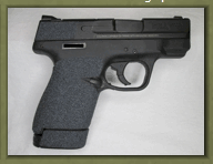 Smith & Wesson M&P Shield 9mm with sand paper pistol grip enhancements.