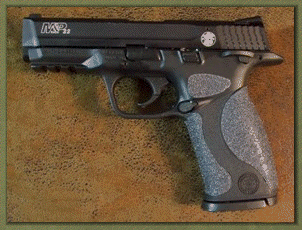 Smith & Wesson M&P 22. 9mm. 40 caliber with sand paper pistol grips installed.
