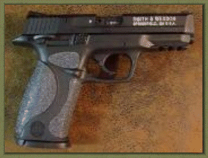 Smith & Wesson M&P 22. 9mm. 40 caliber with sand paper pistol grips installed.