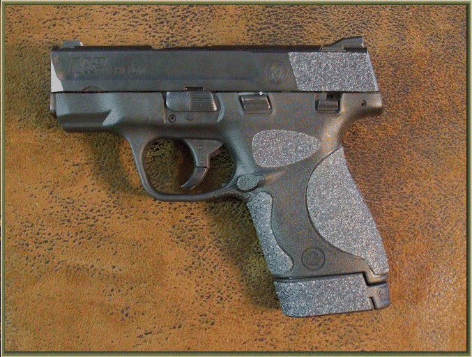Smith & Wesson M&P SHIELD 9mm with sand paper pistol grips installed.