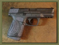 Smith & Wesson M&P COMPACT with sand paper pistol grip enhancements.
