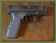 Springfield Armory XDM Compact with sand paper pistol grip enhancements.